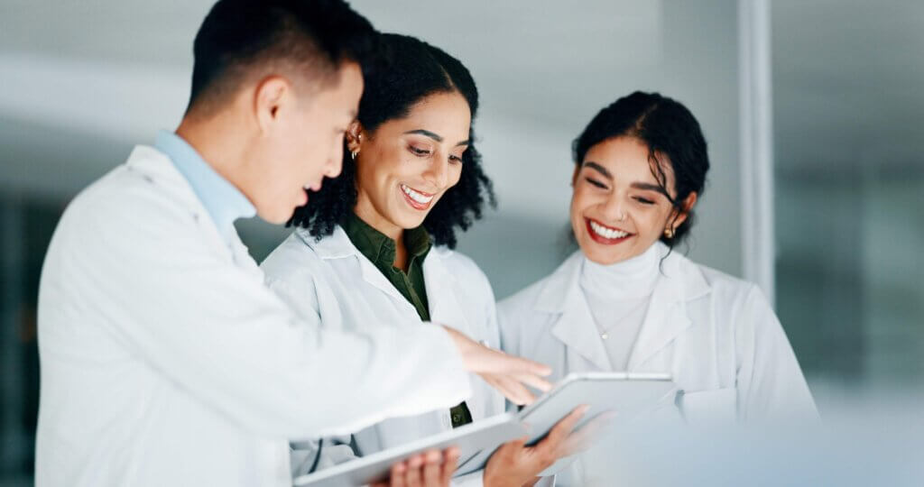 Scientists reviewing records on a tablet, process knowledge management